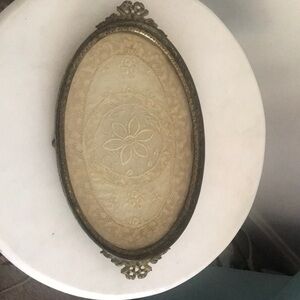 Vintage Oval Metal dresser/bathroom tray with doily between glass